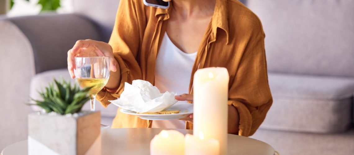 Woman, candles and phone call with smile, happy and content being peaceful, relax or in living room.